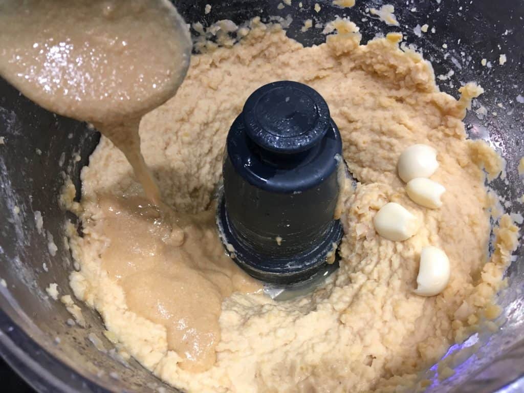 adding tahini to hummus