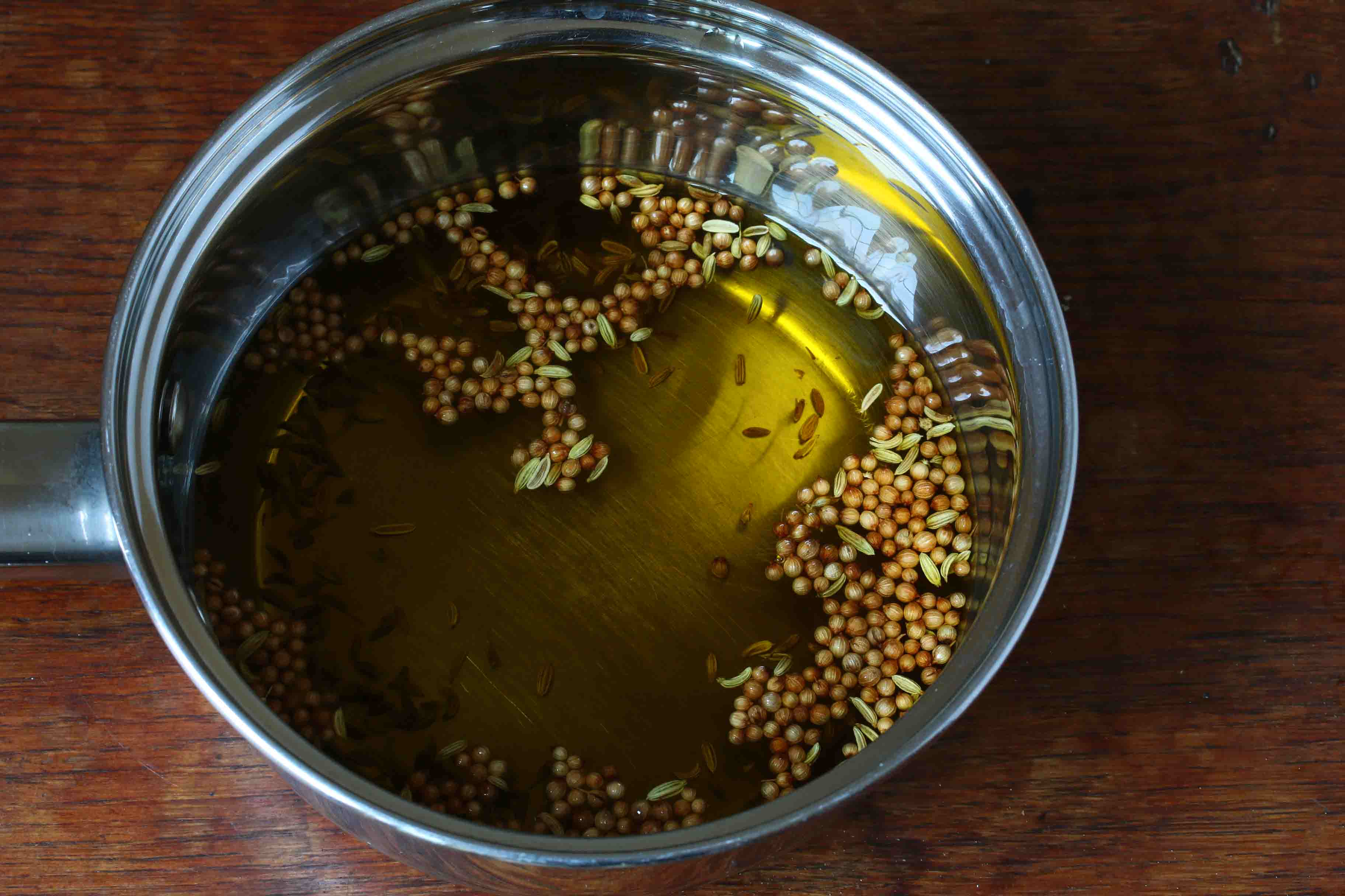 adding olive oil to spices