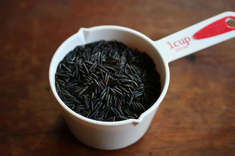 wild rice in white measuring cup
