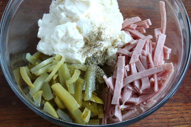 combining meat pickles and mayonnaise in bowl