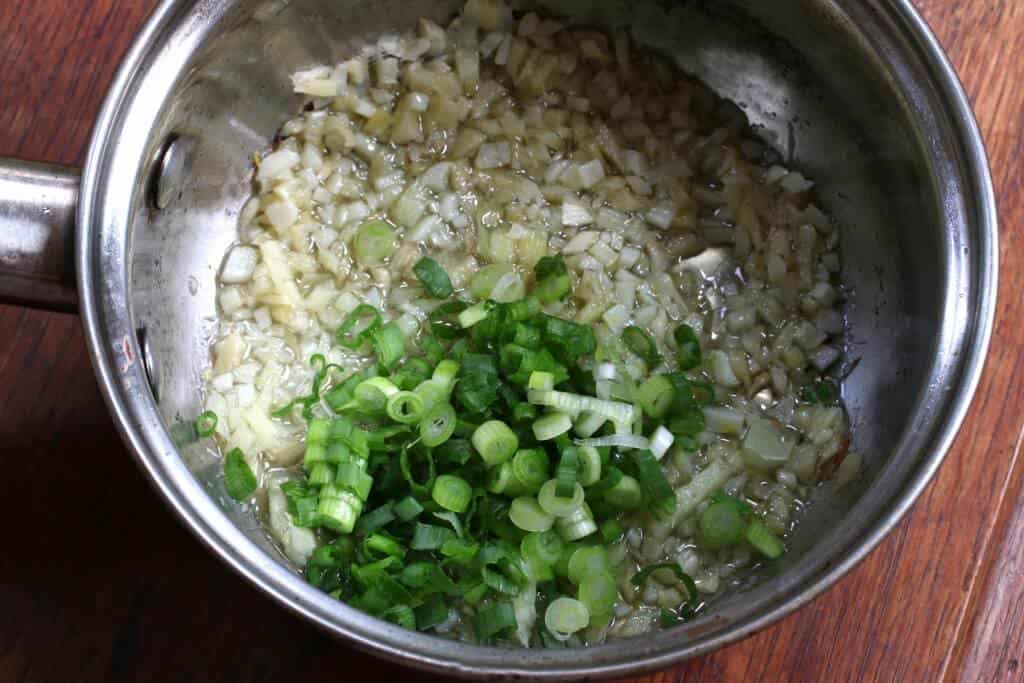 adding ingredients to saucepan