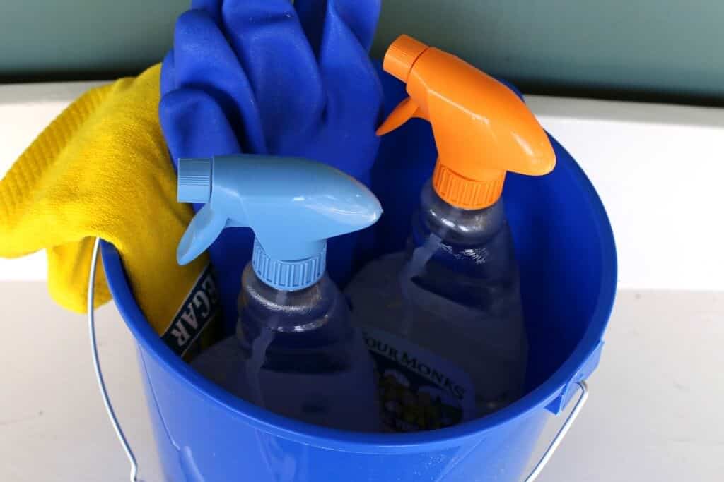 bucket with bottles of vinegar spray
