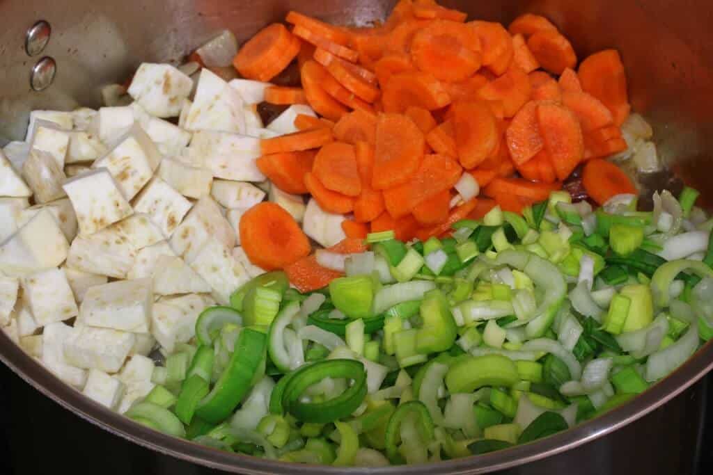adding vegetables to pot