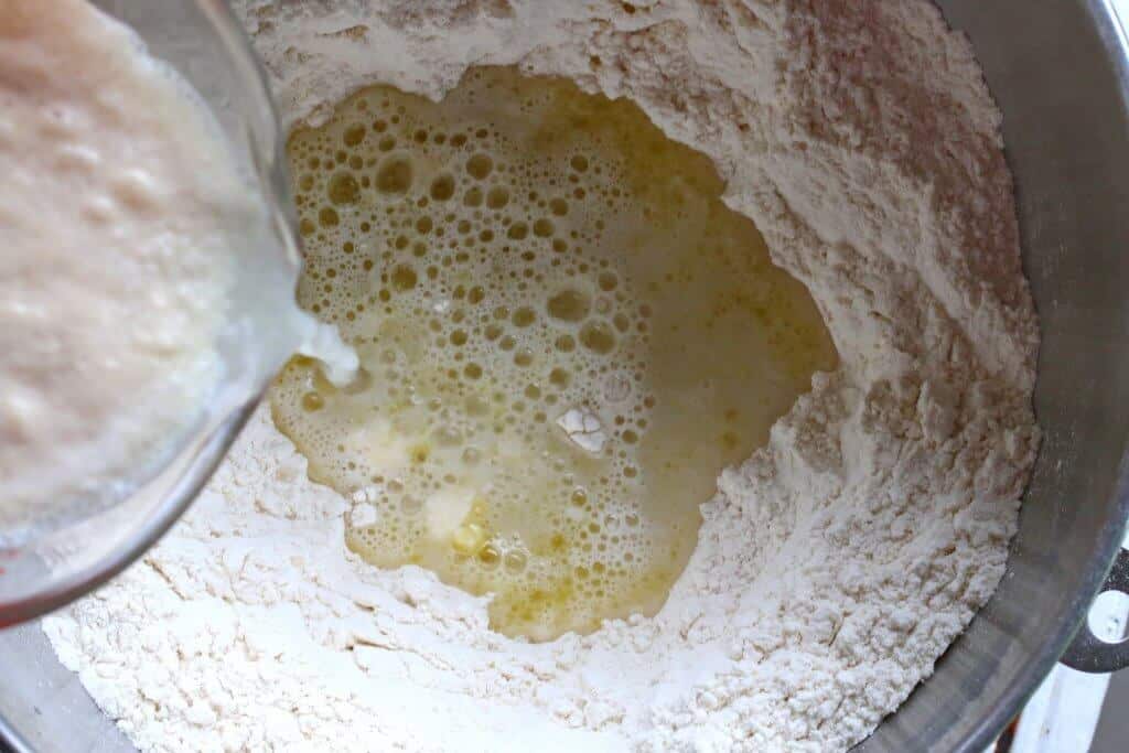 adding yeast and water to flour