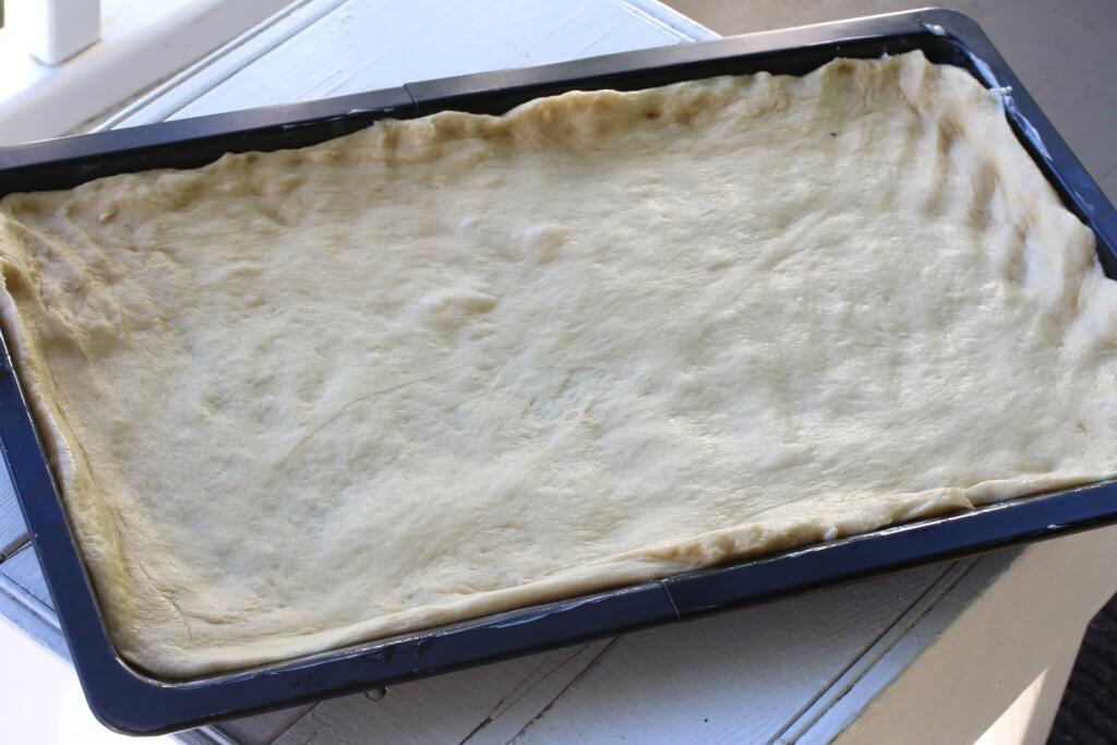 pressing dough on baking sheet