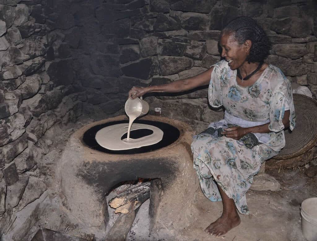 woman making injera