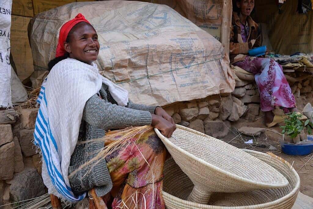 woman making basket for injera