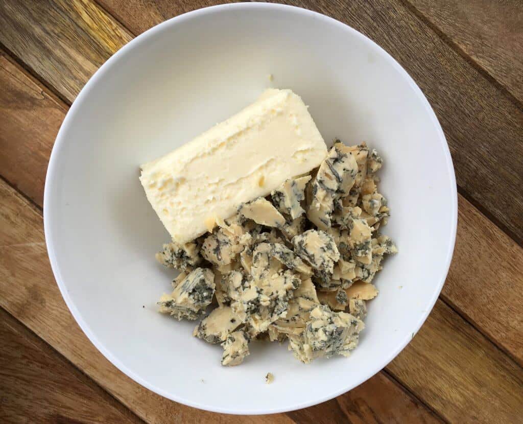 combining butter and blue cheese in bowl