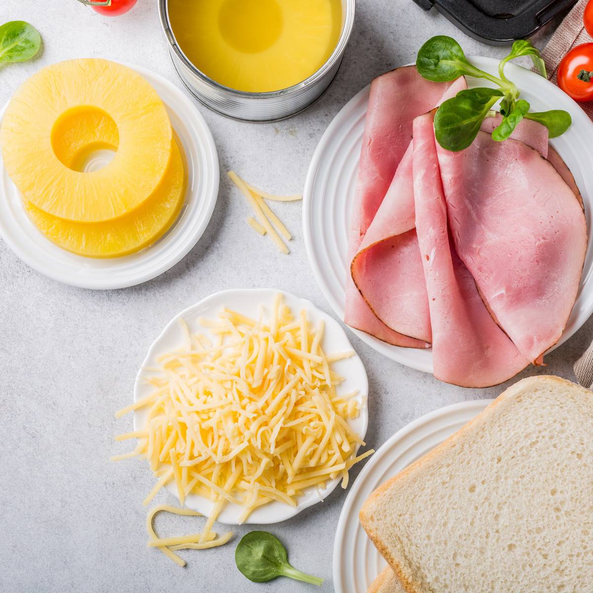 plates with bread cheese ham pineapple