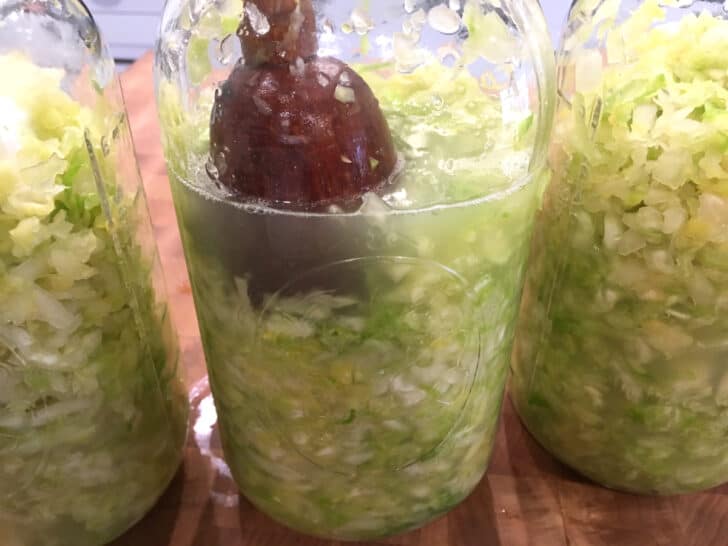 mashing cabbage in jars