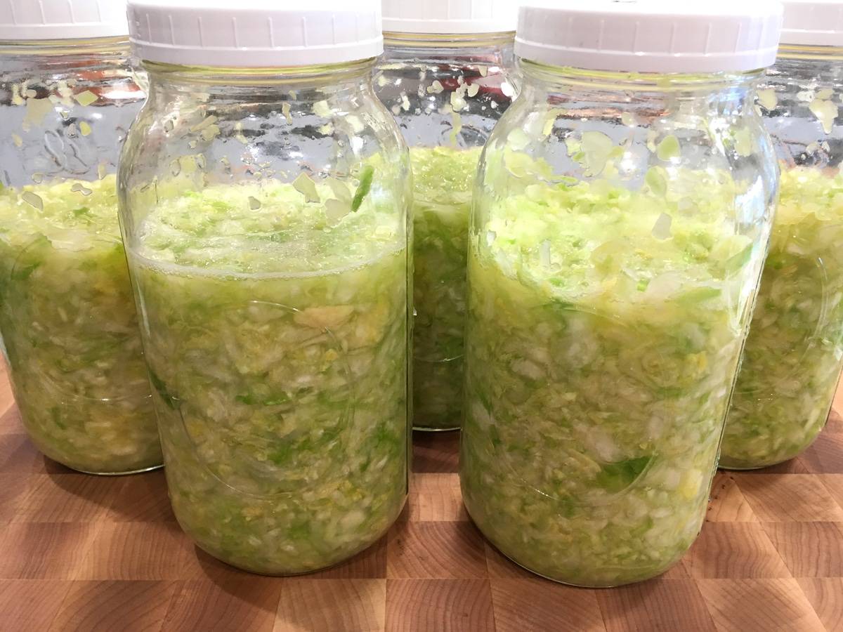 sliced cabbage fermenting in jars