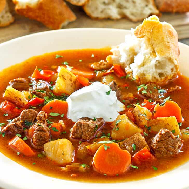 hungarian goulash recipe traditional authentic gulyas beef stew paprika carrots peppers potatoes sour cream caraway