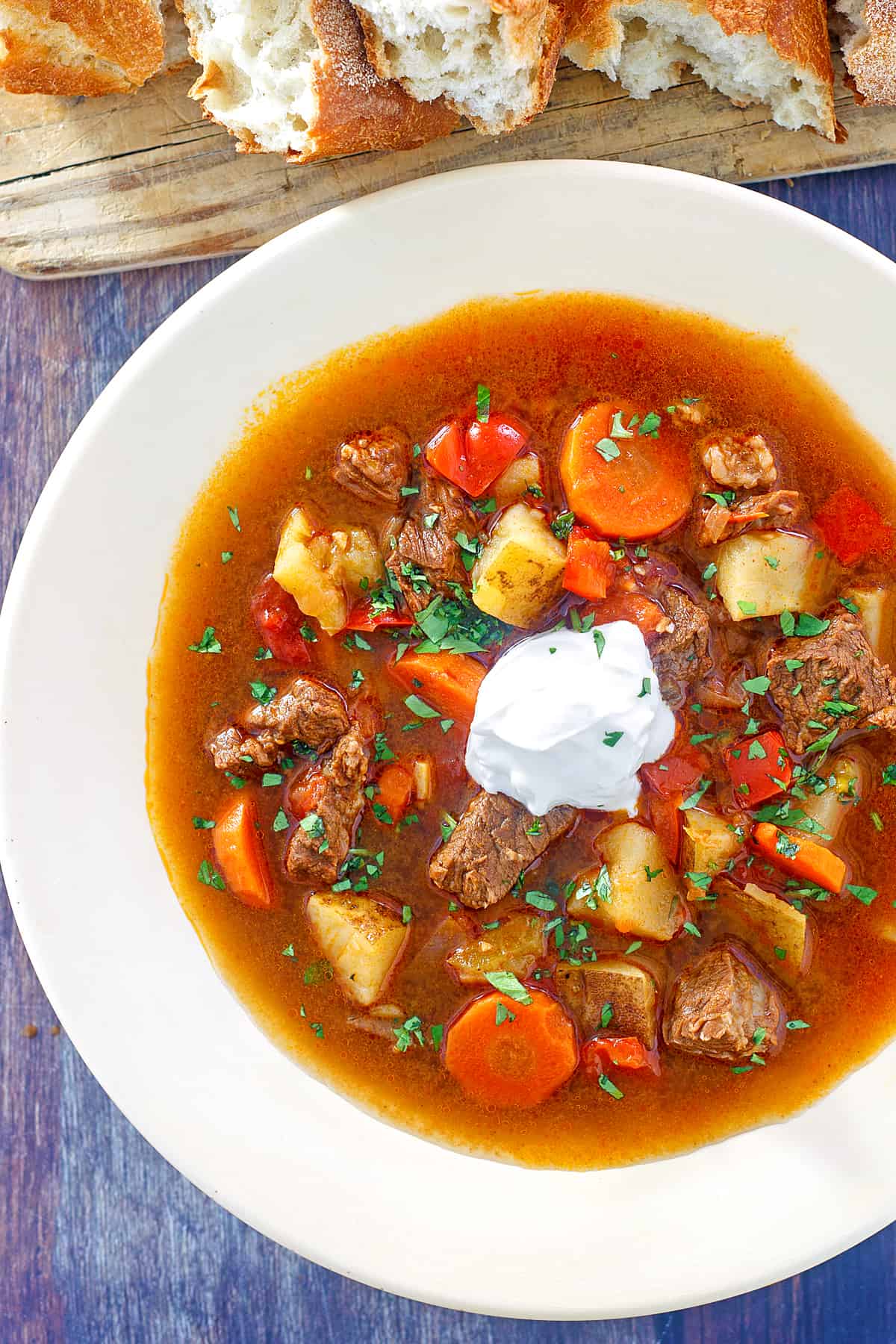 hungarian goulash recipe traditional authentic gulyas beef stew paprika carrots peppers potatoes sour cream caraway