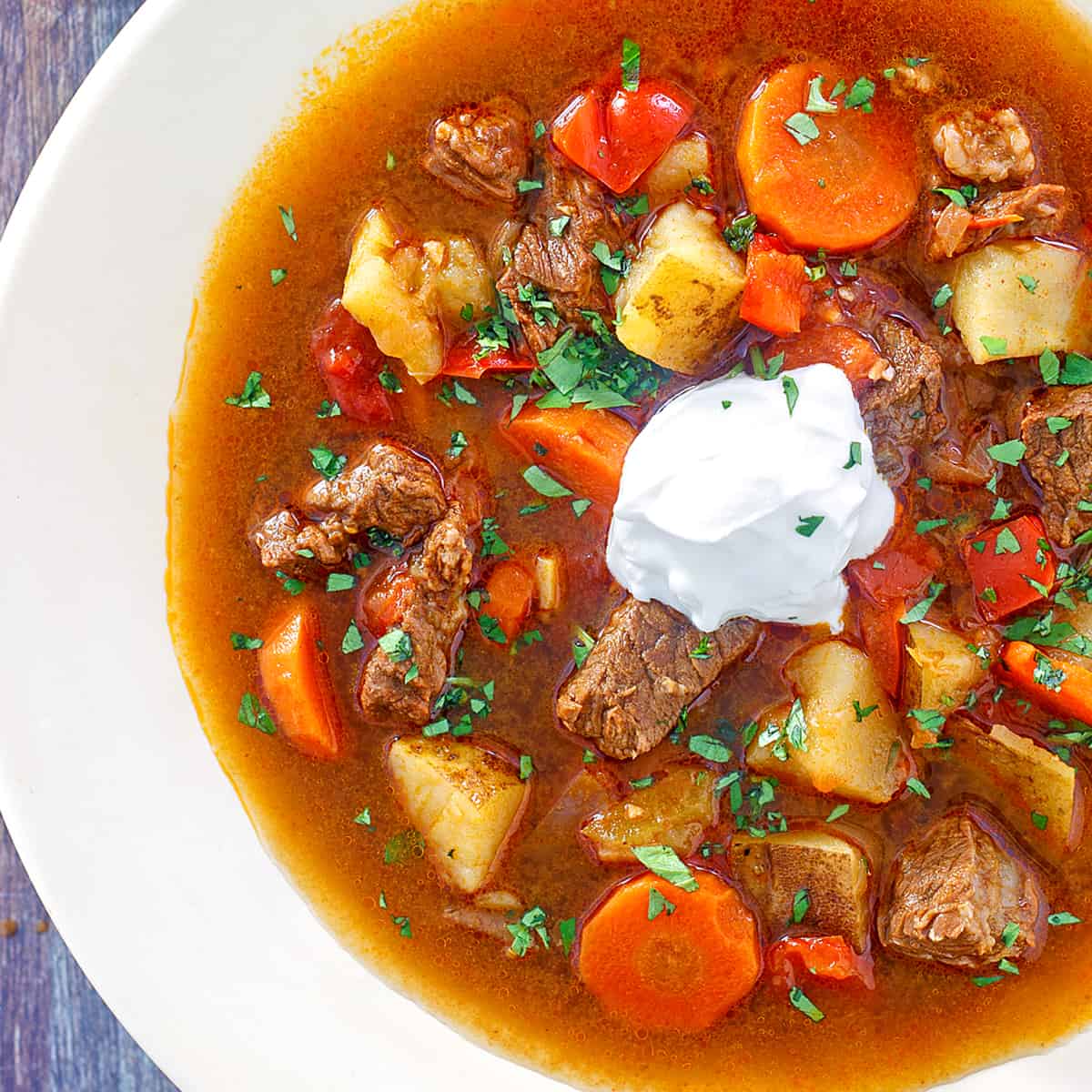 hungarian goulash recipe traditional authentic gulyas beef stew paprika carrots peppers potatoes sour cream caraway