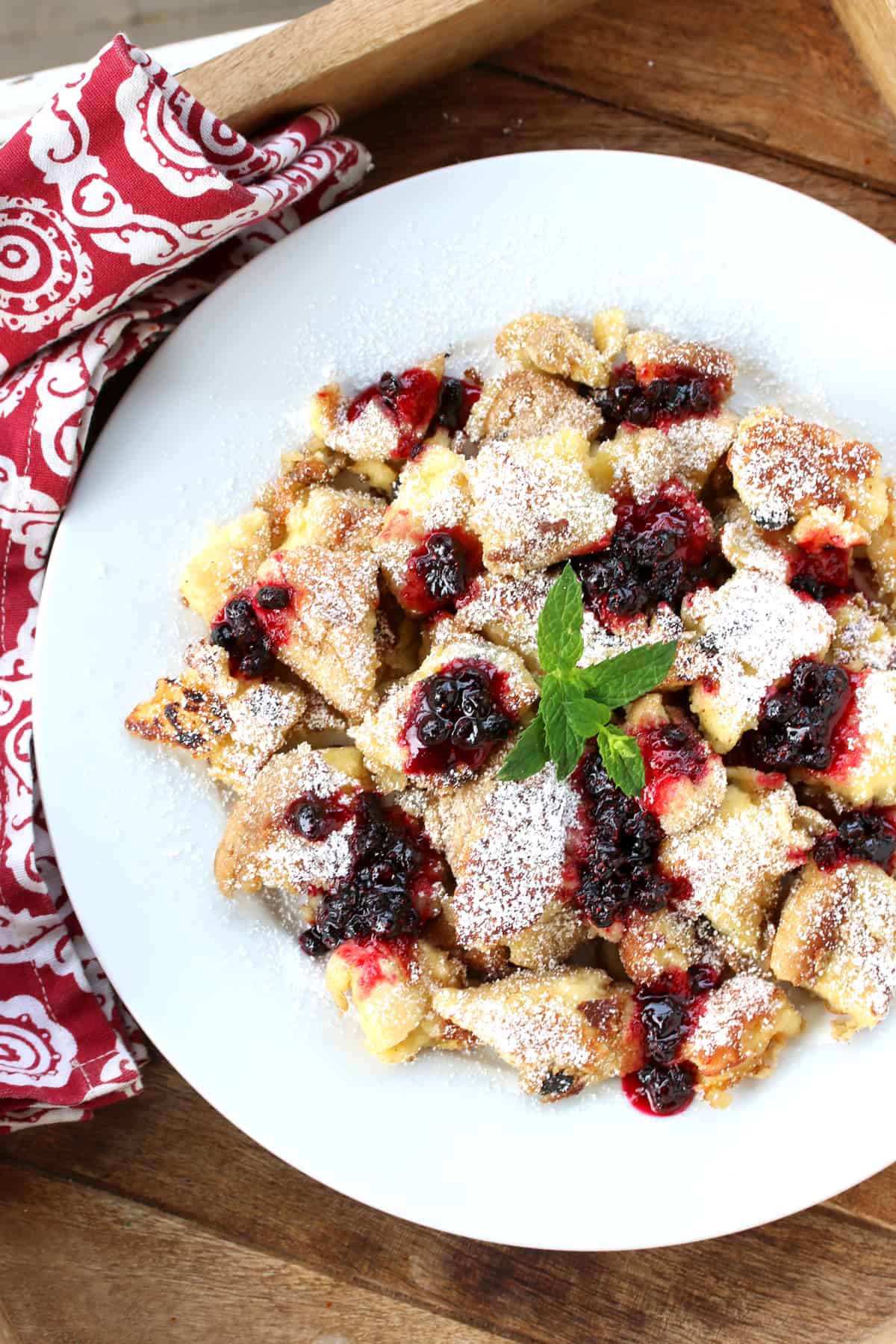 kaiserschmarrn recipe authentic traditional Austrian torn pancakes shredded scrambled rum raisins berries jam compote applesauce plums powdered sugar