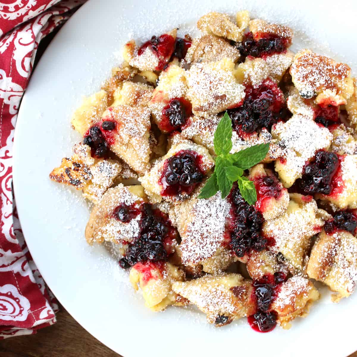 kaiserschmarrn recipe authentic traditional Austrian torn pancakes shredded scrambled rum raisins berries jam compote applesauce plums powdered sugar