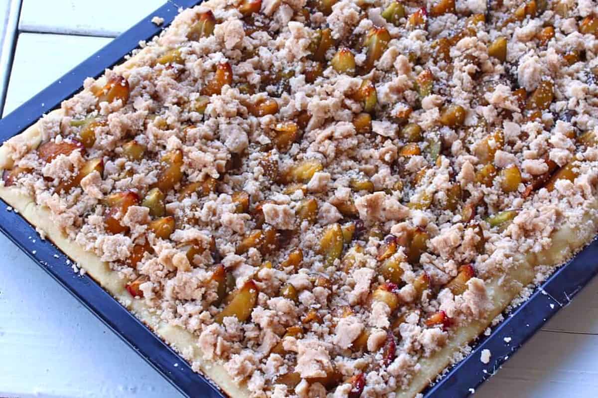 sprinkling the streusel topping over the cake