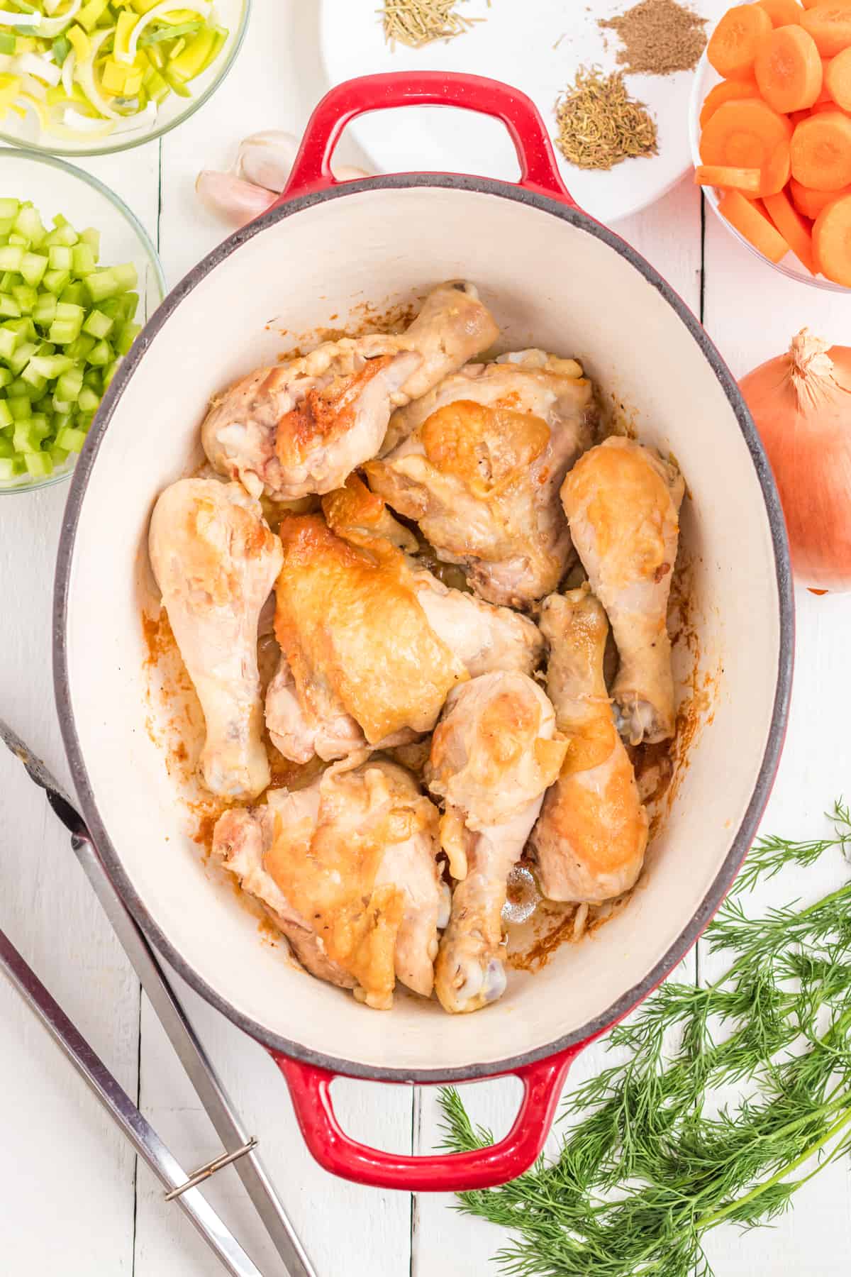 seared chicken pieces in Dutch oven