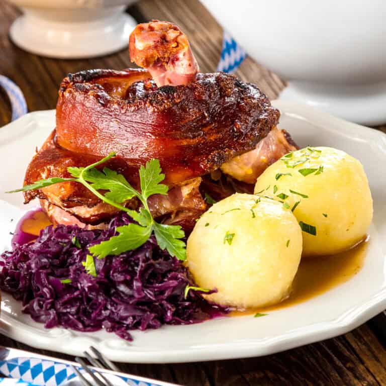 schweinshaxe recipe traditional german pork knuckles roasted grilled broiled crispy skin ham hocks bavarian oktoberfest authentic caraway seeds beer gravy eisbein
