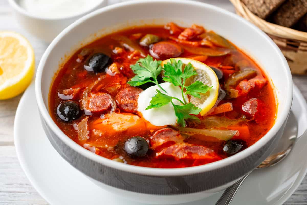 solyanka recipe best traditional authentic russian ukrainian sour soup east german soljanka rezept smoked meat sausage cabbage pickles olives capers