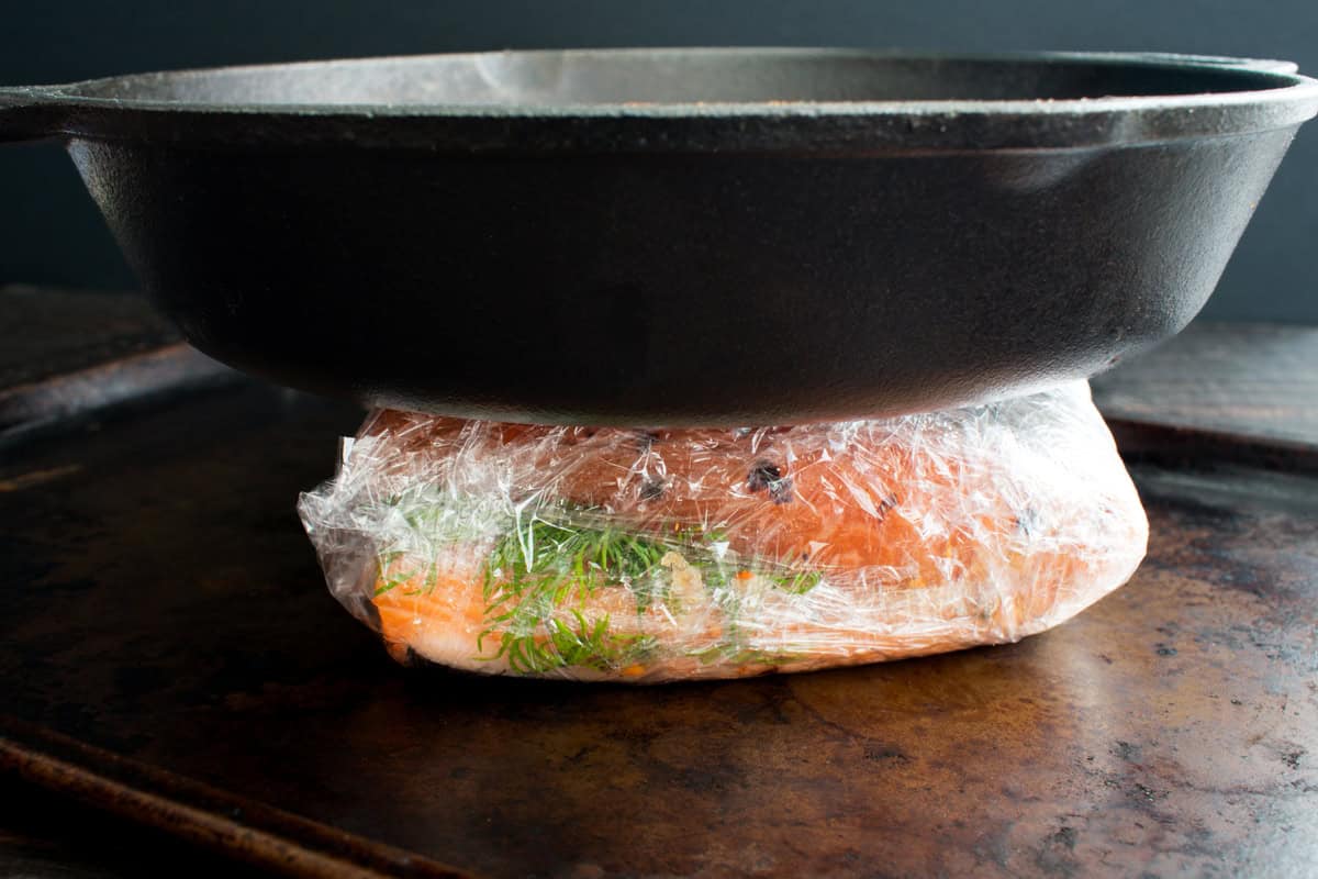 weighing the cured salmon down with a heavy object