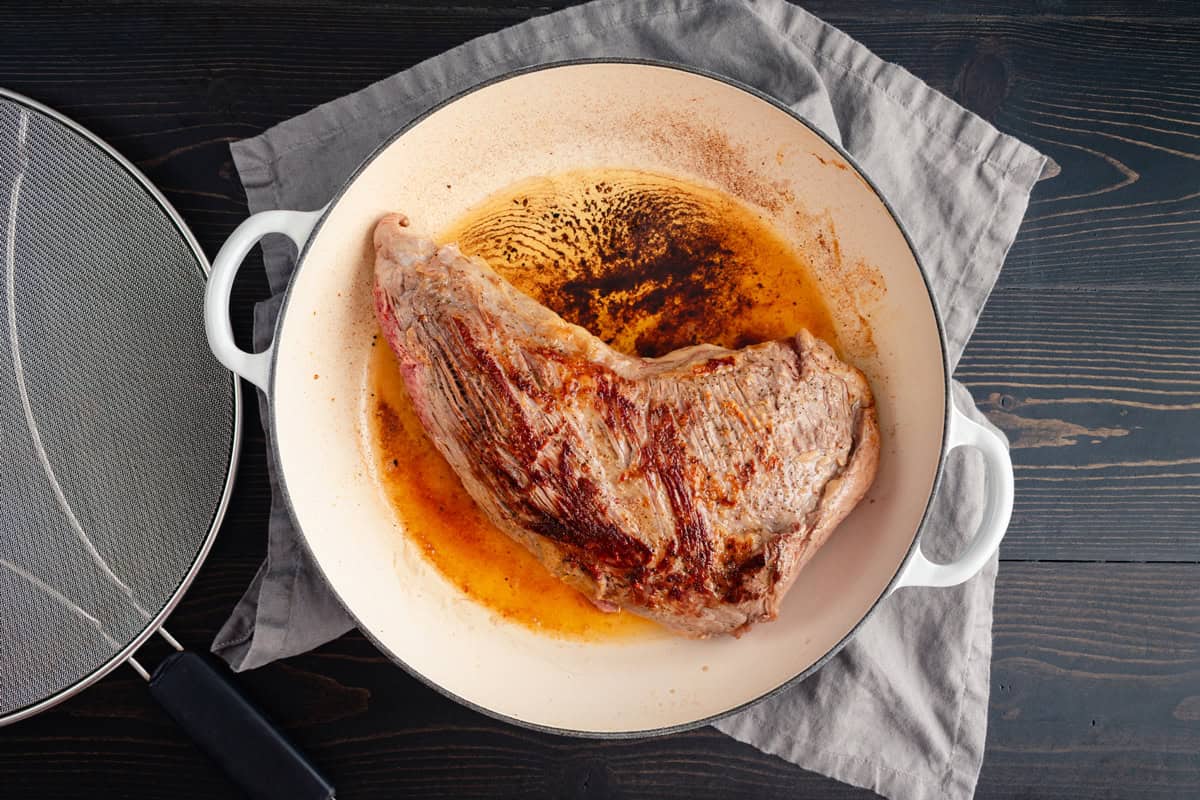 searing the meat on all sides in a Dutch oven